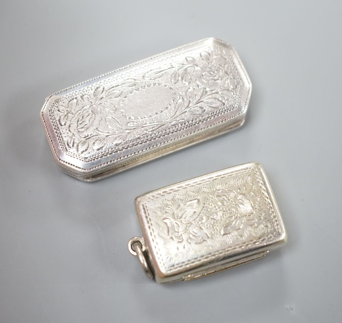 A Victorian silver gilt vinaigrette, by Edward Smith, Birmingham, 1848, 22mm and an earlier octagonal silver vinaigrette by Joseph Wilmore, Birmingham, 1818.